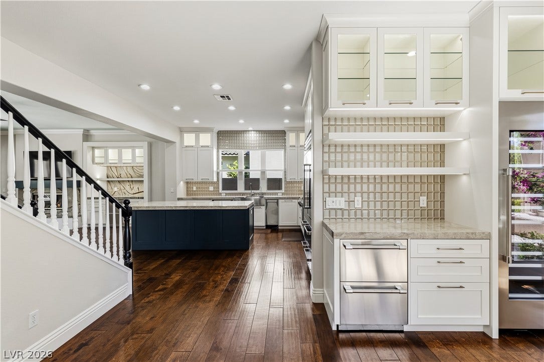 1201 Mersault Court, Las Vegas, NV 89144 Gleaming hardwood floors and a spacious island anchor this updated culinary space.