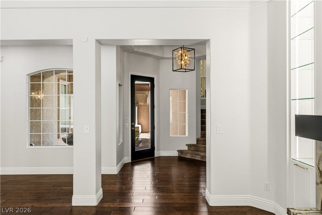 1201 Mersault Court, Las Vegas, NV 89144 Rich hardwood floors lead past wide arched openings into a welcoming entrance foyer.