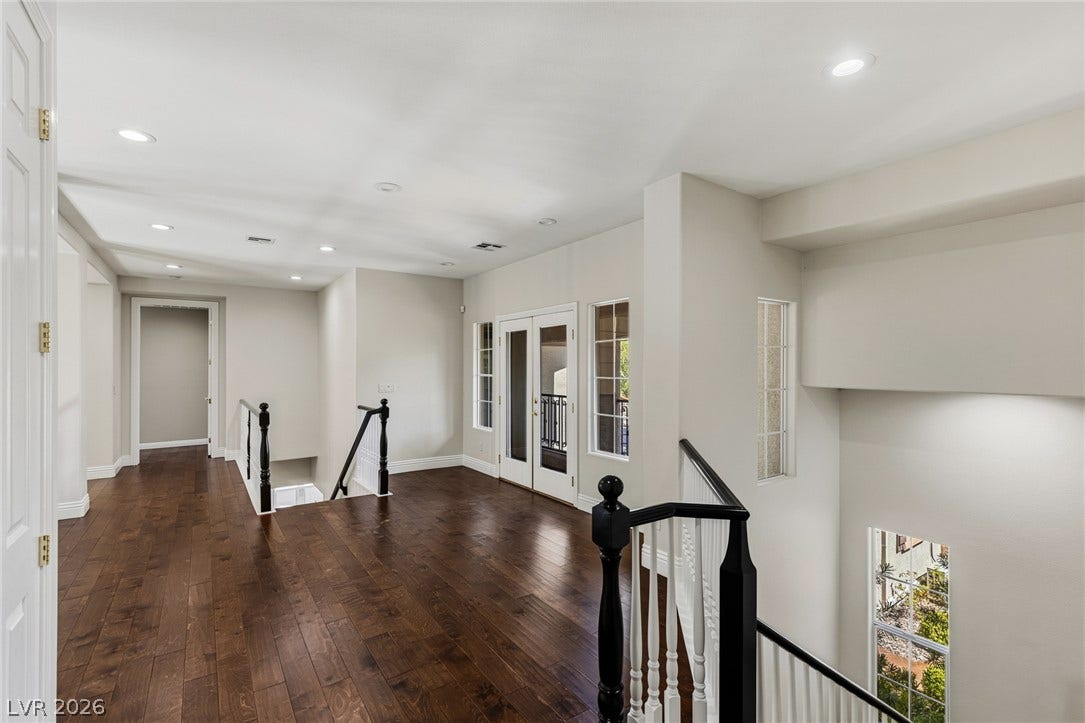 1201 Mersault Court, Las Vegas, NV 89144 Rich hardwood floors and recessed lighting anchor this open second-floor landing.