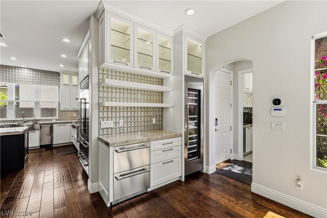 1201 Mersault Court, Las Vegas, NV 89144 Rich hardwood floors anchor this functional wet bar area featuring integrated wine refrigeration.