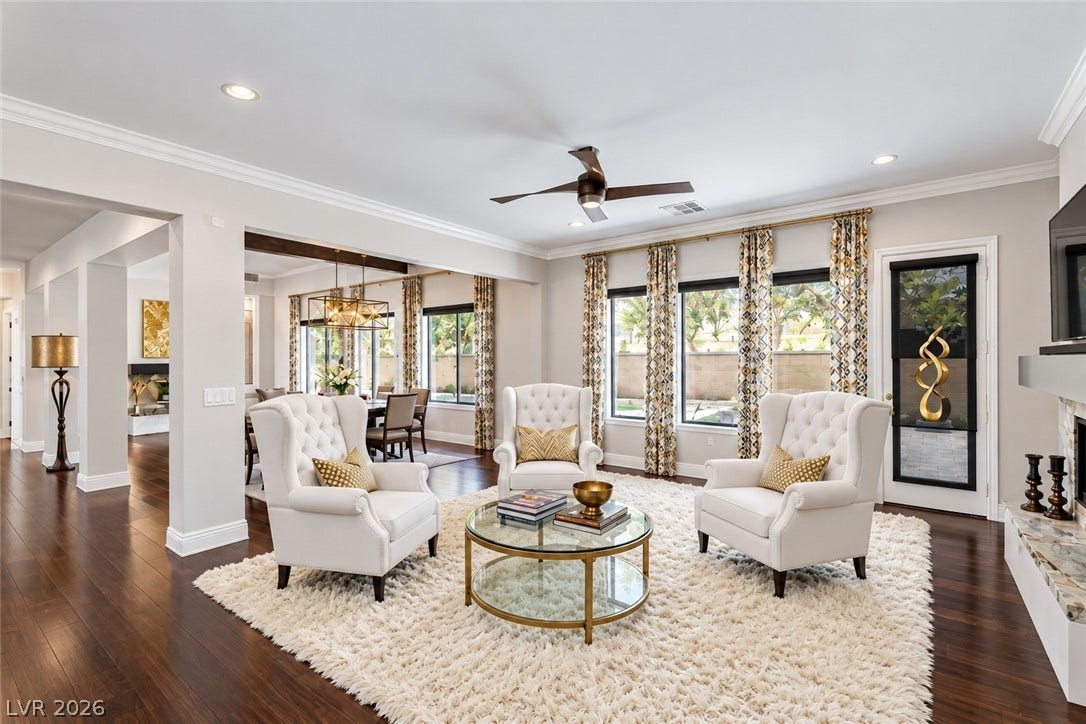 1201 Mersault Court, Las Vegas, NV 89144 Gleaming hardwood floors and classic crown moldings enhance this elegant open-concept living space.