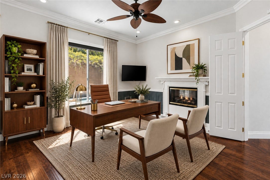 1201 Mersault Court, Las Vegas, NV 89144 Rich wood floors and a fireplace create a warm atmosphere in this home office.