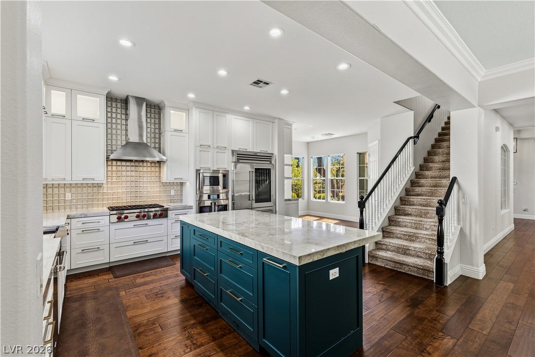 1201 Mersault Court, Las Vegas, NV 89144 Rich hardwood floors complement a modern kitchen design with premium finishes and an island.