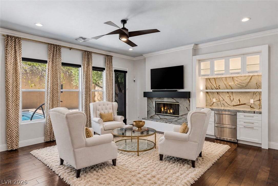 1201 Mersault Court, Las Vegas, NV 89144 Rich hardwood floors complement a modern fireplace and custom built-in wet bar.