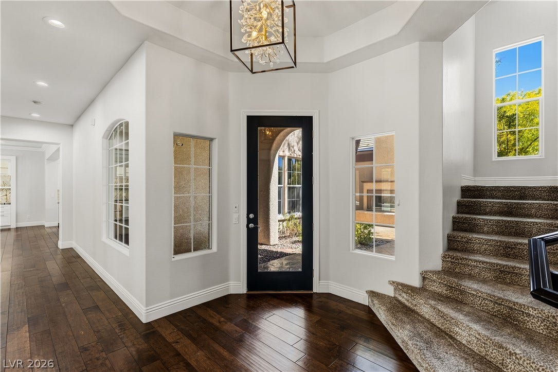 1201 Mersault Court, Las Vegas, NV 89144 Rich hardwood floors welcome guests into an airy entrance foyer featuring a striking tray ceiling.