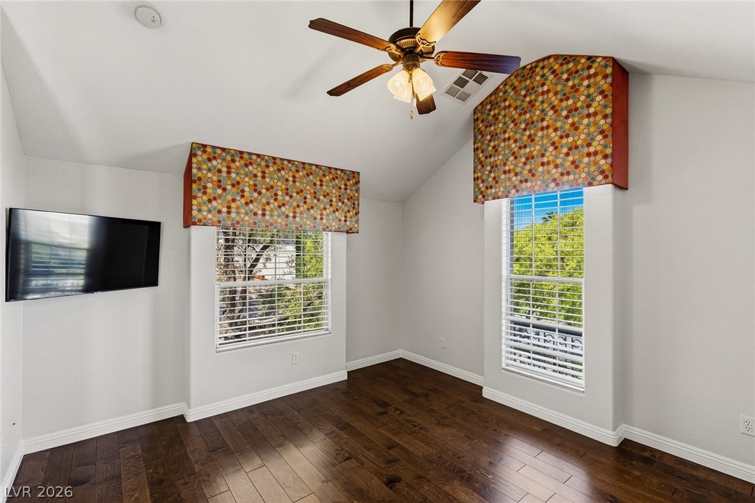 1201 Mersault Court, Las Vegas, NV 89144 Rich hardwood flooring complements vaulted ceilings and two bright windows framing serene outdoor views.