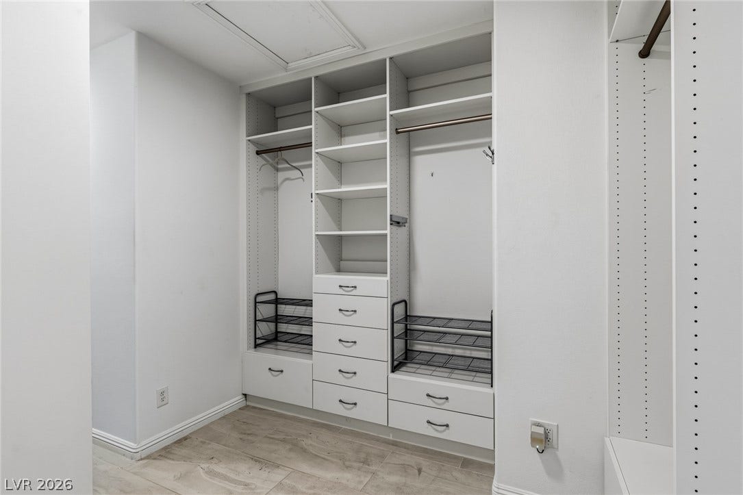 1201 Mersault Court, Las Vegas, NV 89144 Ample built-in storage and tile flooring define this organized walk-in closet space.