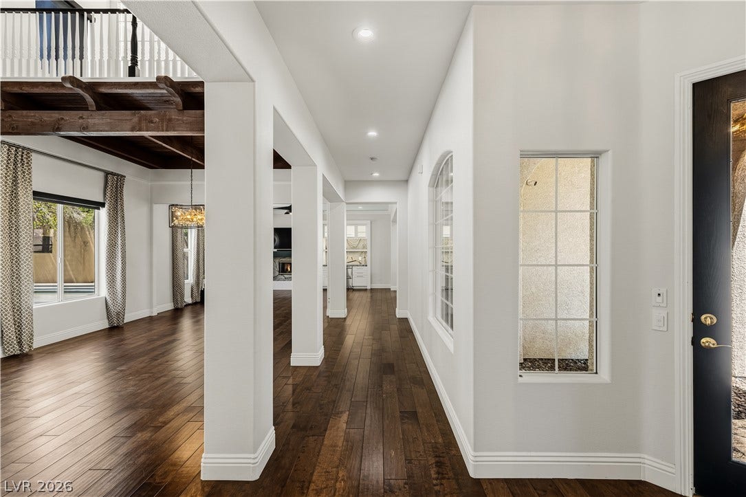 1201 Mersault Court, Las Vegas, NV 89144 Rich hardwood flooring guides the eye through this airy entrance hall with structural columns.