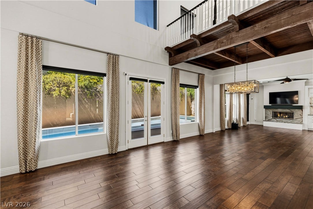 1201 Mersault Court, Las Vegas, NV 89144 Rich hardwood floors sweep through an airy, open-concept living area with soaring ceilings.