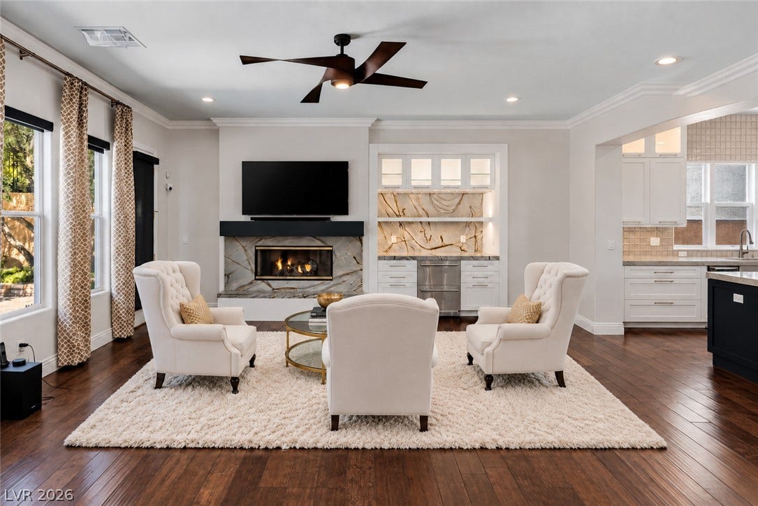 1201 Mersault Court, Las Vegas, NV 89144 Gleaming hardwood floors and a customized stone fireplace define this expansive living area.