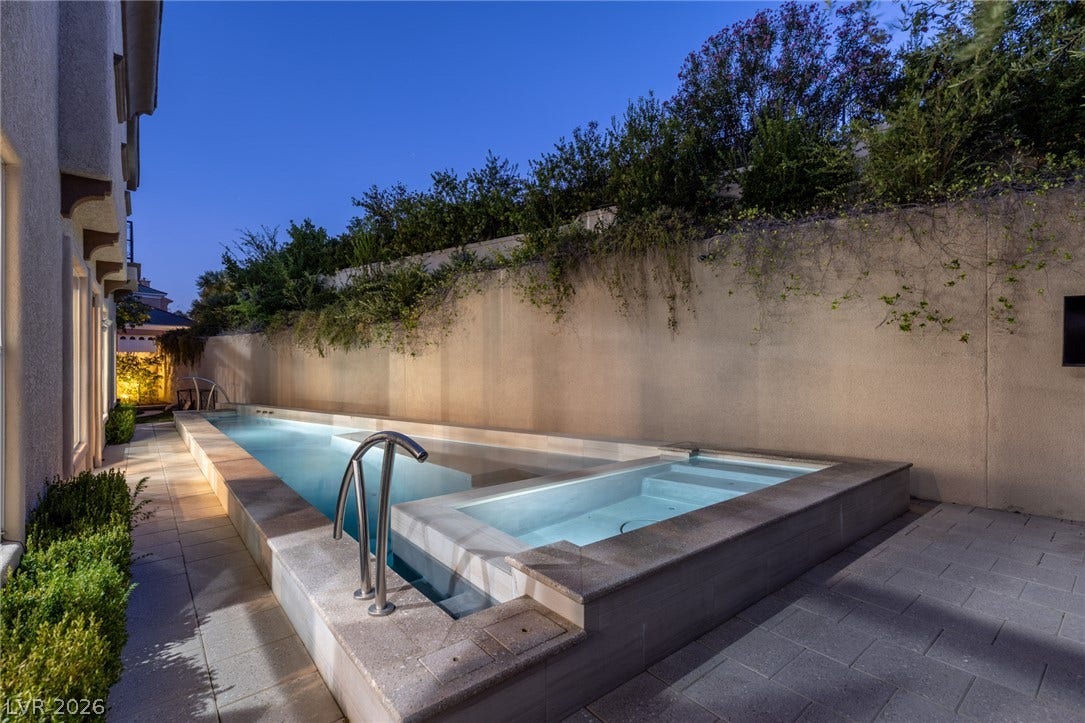 1201 Mersault Court, Las Vegas, NV 89144 A sleek lap pool and integrated spa sit nestled alongside a private stone-paved patio.