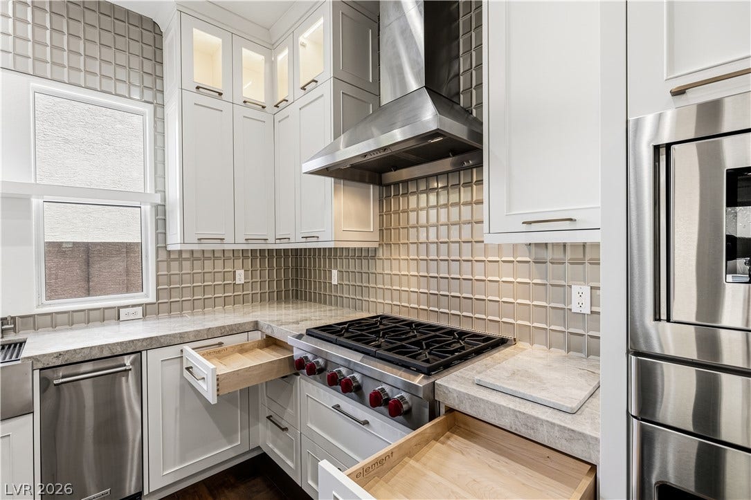 1201 Mersault Court, Las Vegas, NV 89144 Gleaming stone countertops and modern built-in cabinetry surround a professional-grade gas range.