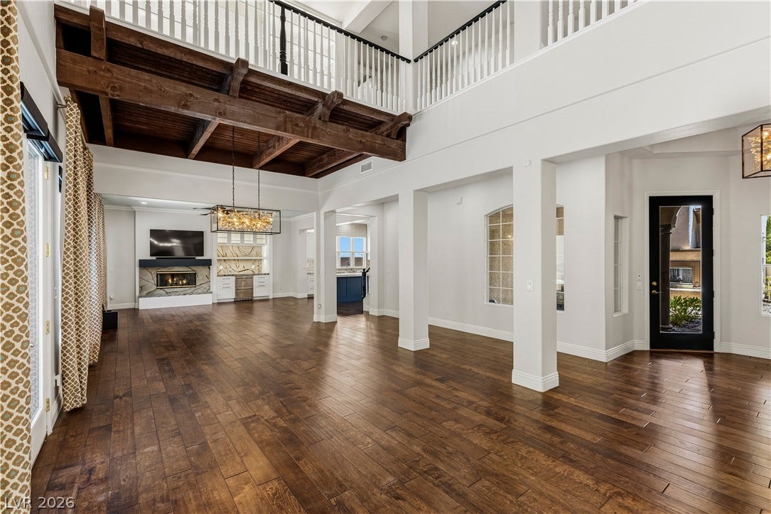 1201 Mersault Court, Las Vegas, NV 89144 Gleaming hardwood floors and a beamed ceiling define this spacious open living area.