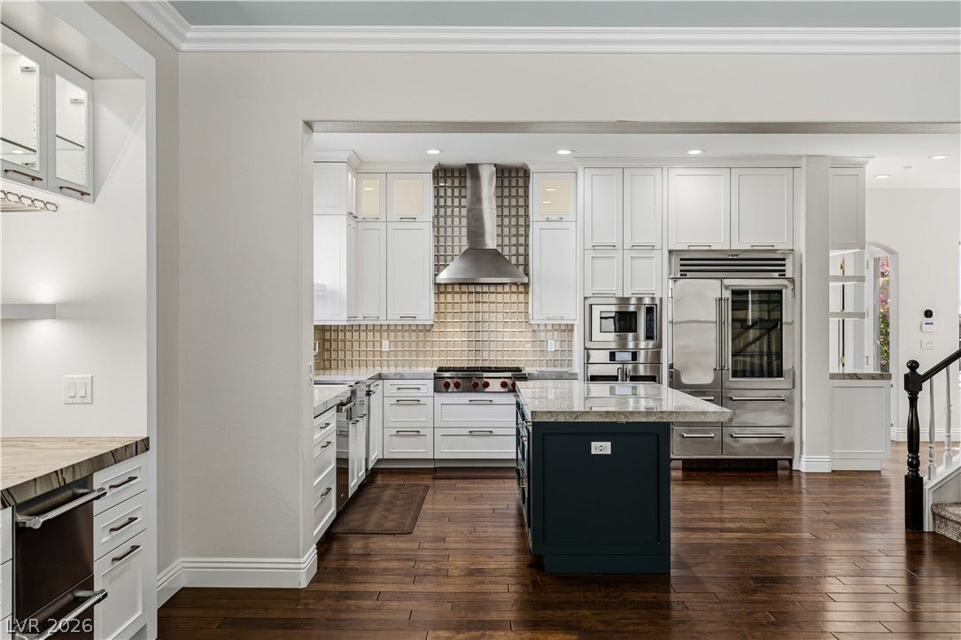 1201 Mersault Court, Las Vegas, NV 89144 Gleaming hardwood floors and a spacious central quartzite island anchor this elegantly designed gourmet kitchen.