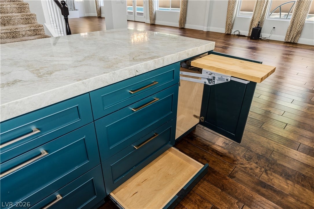 1201 Mersault Court, Las Vegas, NV 89144 Polished stone countertops pair beautifully with rich hardwood flooring in this open layout.