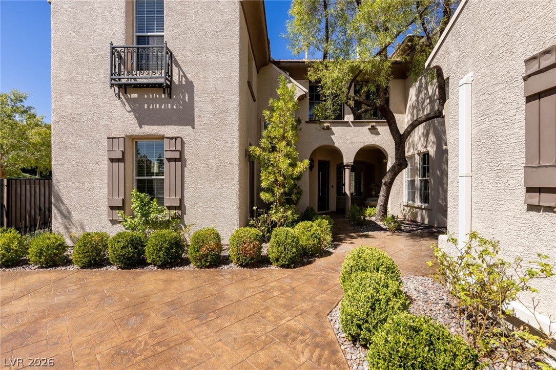 1201 Mersault Court, Las Vegas, NV 89144 Arched entryways, and classic shutters define this elegant exterior courtyard.