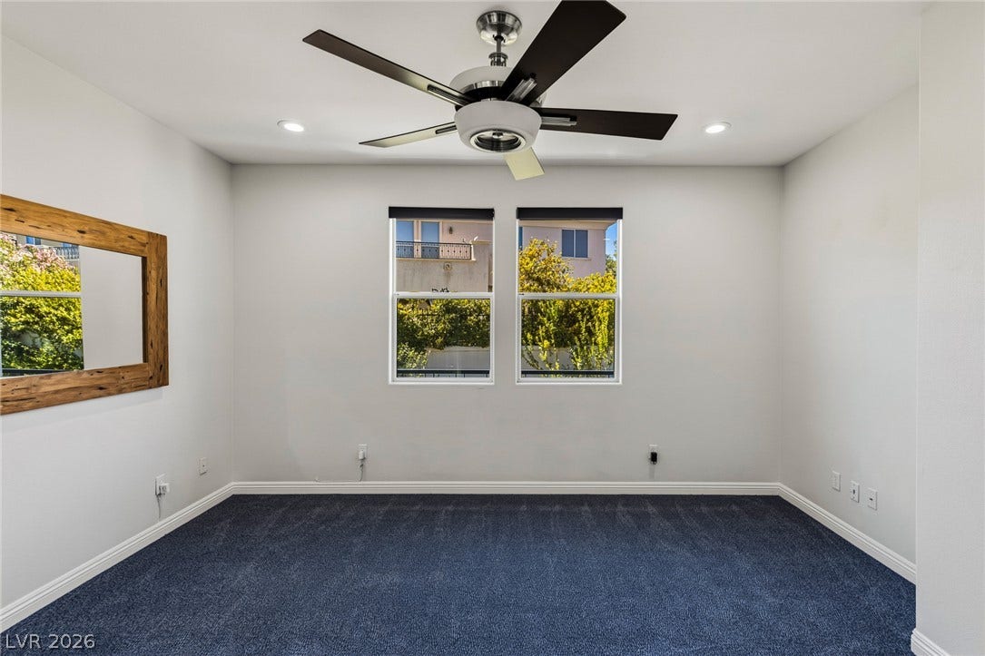 1201 Mersault Court, Las Vegas, NV 89144 Plush carpeting anchors this versatile room under high ceilings with recessed lighting.
