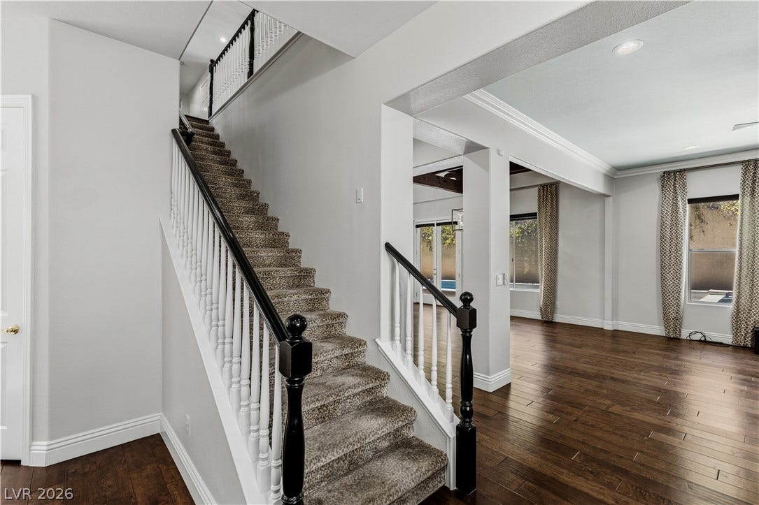 1201 Mersault Court, Las Vegas, NV 89144 Back staircase. Rich hardwood floors and elegant crown molding define this open entry and staircase.