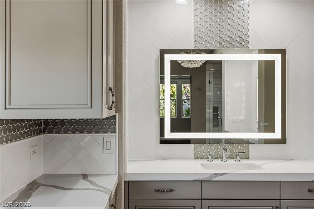 1201 Mersault Court, Las Vegas, NV 89144 Custom cabinetry and patterned tile details enhance this modern vanity station.