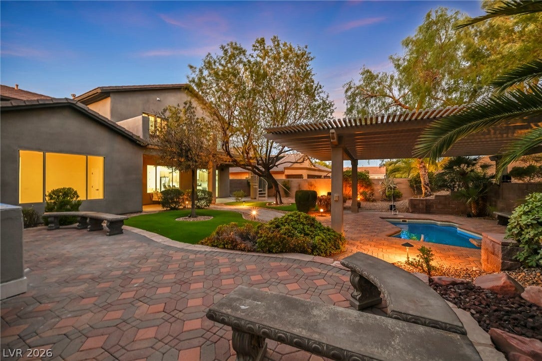 17 Winding Road, Henderson, NV 89052 Inviting stone-paved pathways lead through manicured grounds to an elegant poolside patio.
