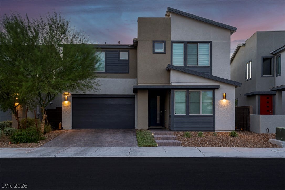 6849 Desert Finch Street, North Las Vegas, NV 89084 Modern architectural lines and a paved driveway define this contemporary two-story home.