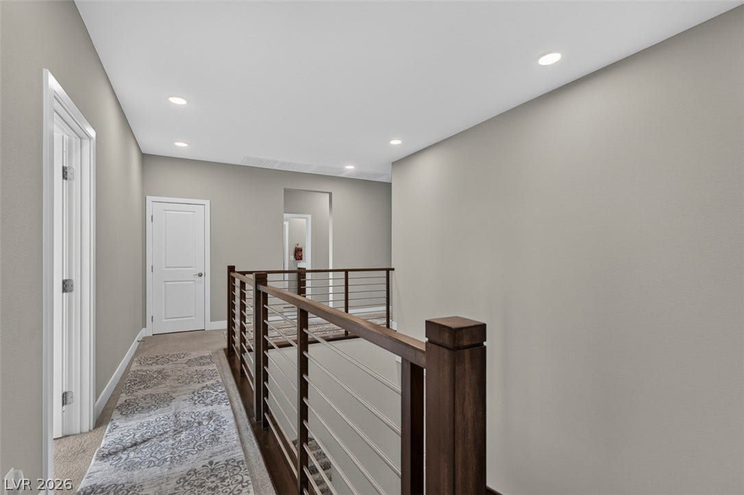 6849 Desert Finch Street, North Las Vegas, NV 89084 A spacious upper-level landing features recessed lighting and modern horizontal cable railings.