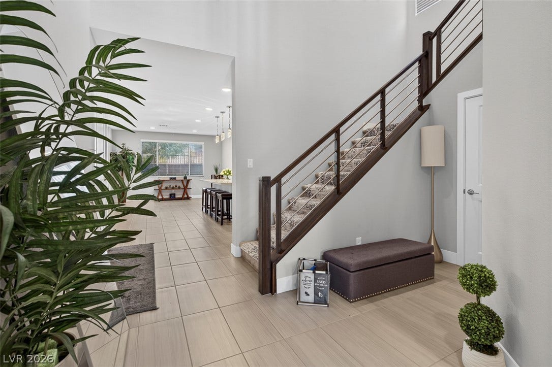 6849 Desert Finch Street, North Las Vegas, NV 89084 High ceilings and clean tile flooring create an inviting entryway with a modern staircase.
