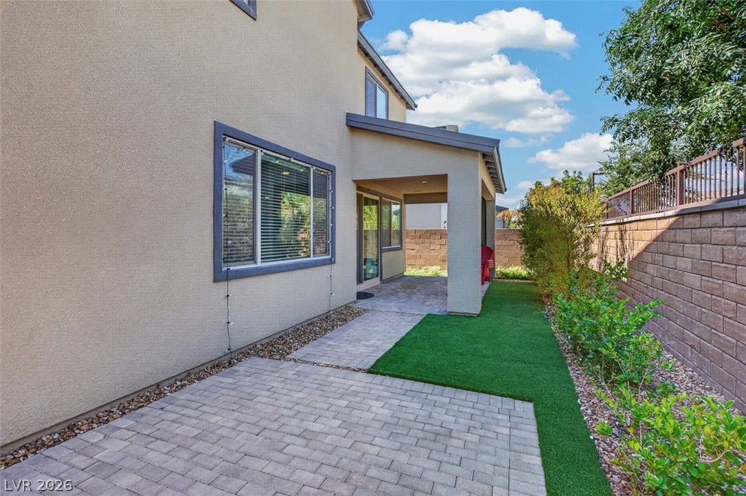 6849 Desert Finch Street, North Las Vegas, NV 89084 Neat paver walkways and a covered patio define this low-maintenance backyard space.