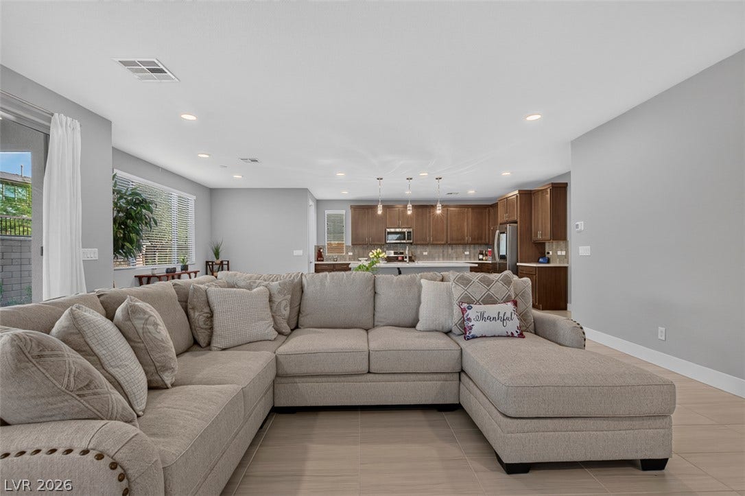 6849 Desert Finch Street, North Las Vegas, NV 89084 An open floorplan seamlessly connects the comfortable living area with a modern kitchen space.