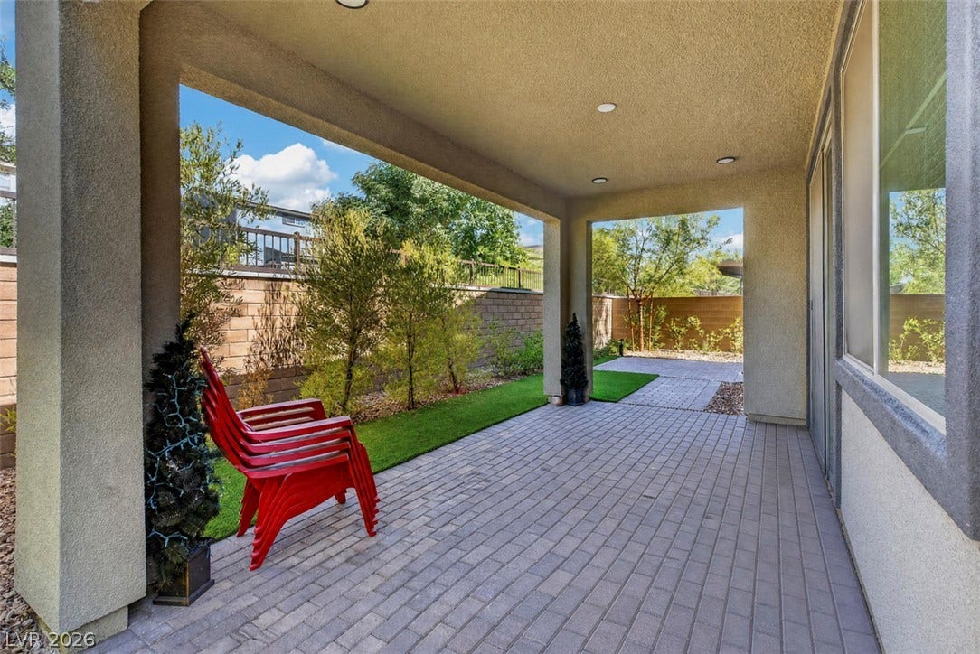 6849 Desert Finch Street, North Las Vegas, NV 89084 A sheltered brick paver patio opens directly to the manicured yard.