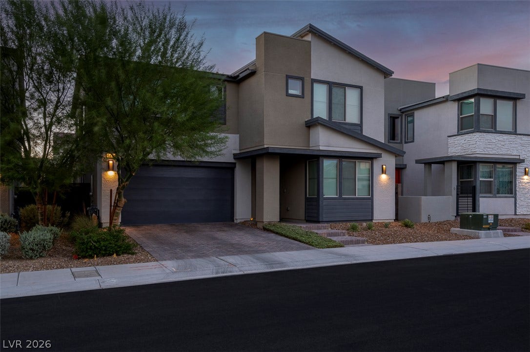 6849 Desert Finch Street, North Las Vegas, NV 89084 Modern architectural lines and stucco finishes define this contemporary two-story home with an attached garage.