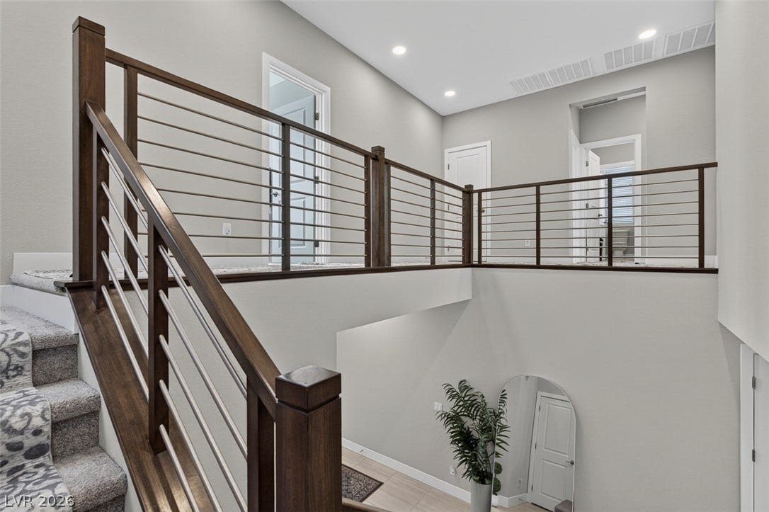 6849 Desert Finch Street, North Las Vegas, NV 89084 Modern cable railings border the upper hallway overlooking the entry below.