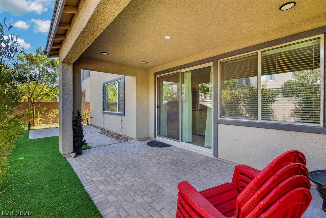 6849 Desert Finch Street, North Las Vegas, NV 89084 A covered back patio with brick pavers connects seamlessly to the main living area.
