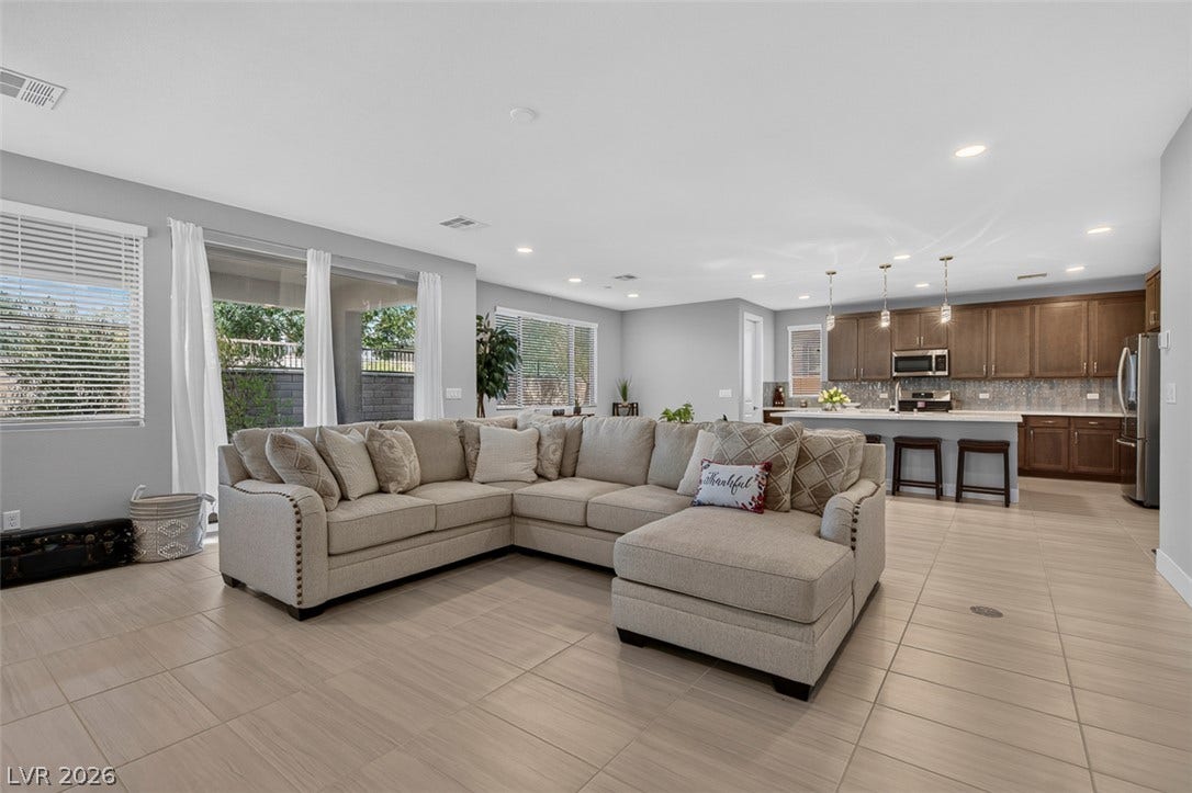 6849 Desert Finch Street, North Las Vegas, NV 89084 Smooth tile flooring and recessed lighting define this open concept main living area.