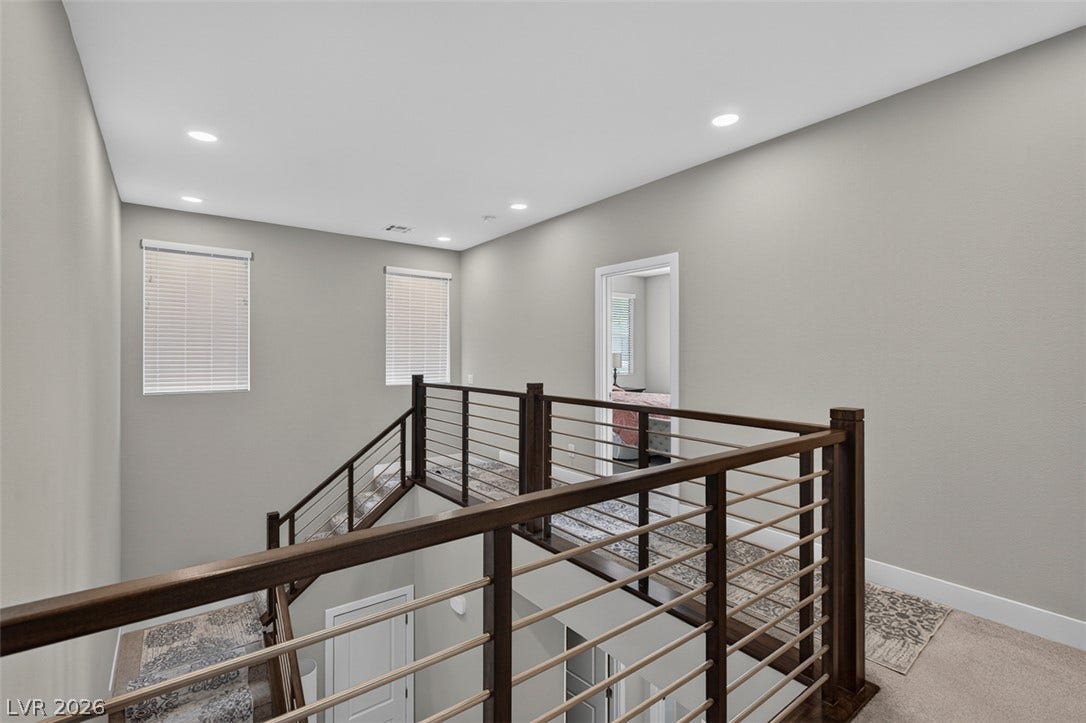 6849 Desert Finch Street, North Las Vegas, NV 89084 An open upper hallway features contemporary horizontal cable railings overlooking the lower level.