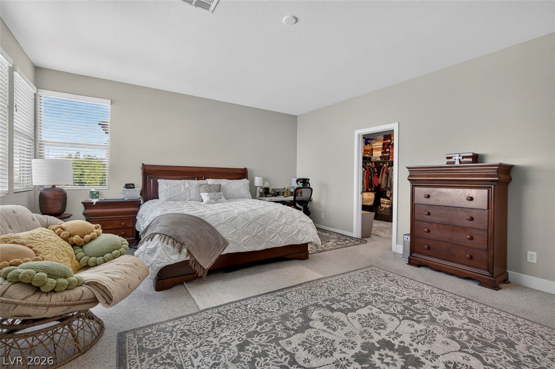 6849 Desert Finch Street, North Las Vegas, NV 89084 A spacious bedroom offers plush carpeting and a large walk-in closet.