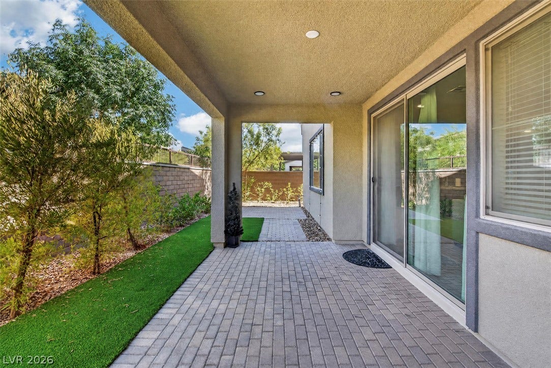 6849 Desert Finch Street, North Las Vegas, NV 89084 An inviting covered patio features modern pavers and direct access through large sliding glass doors.