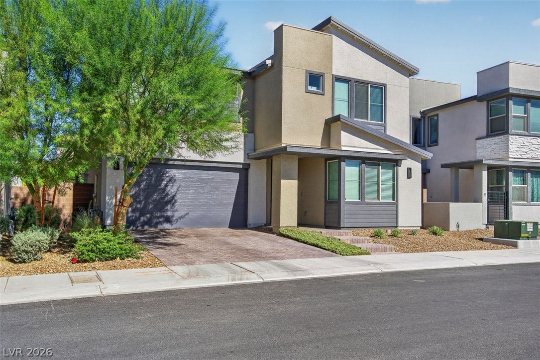 6849 Desert Finch Street, North Las Vegas, NV 89084 Striking contemporary architecture pairs with a paved driveway and low-maintenance landscaping.