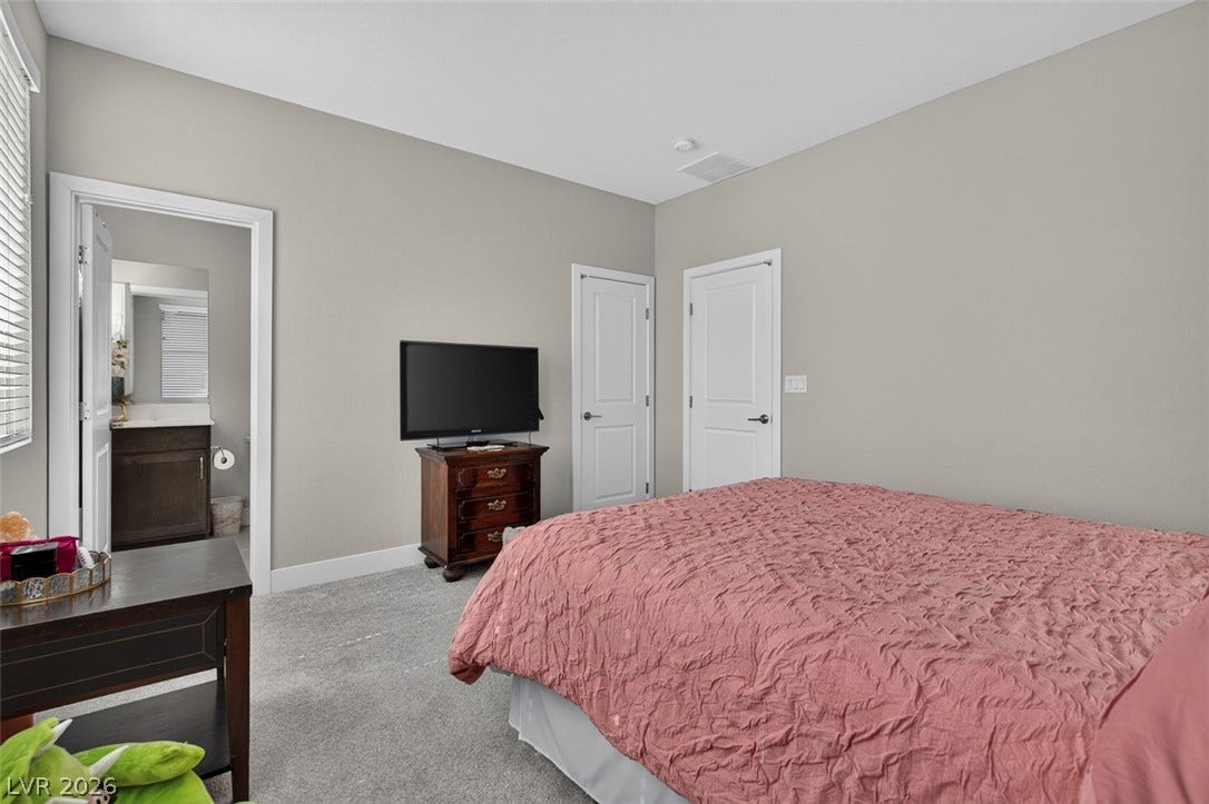 6849 Desert Finch Street, North Las Vegas, NV 89084 An inviting Bedroom with ensuite bathroom. bedroom features plush carpeting and direct access to an en-suite bathroom.