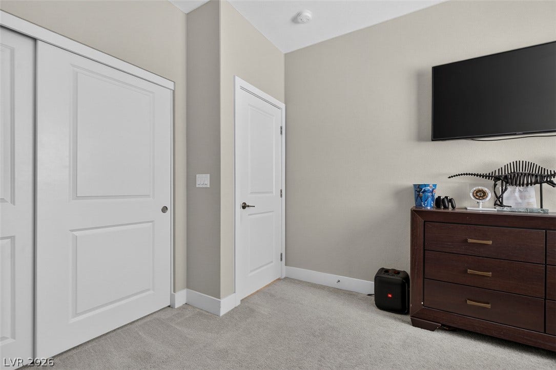 6849 Desert Finch Street, North Las Vegas, NV 89084 Neutral walls and plush carpeting provide a comfortable foundation in this versatile bedroom.