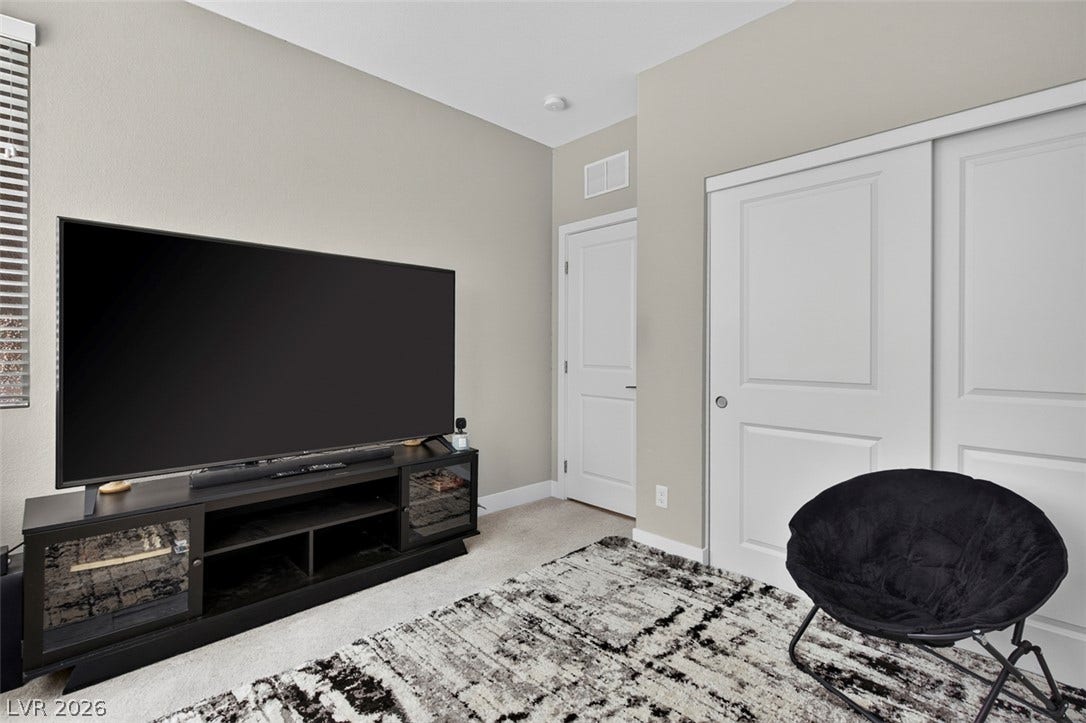 6849 Desert Finch Street, North Las Vegas, NV 89084 Smooth neutral walls and soft carpeting define this versatile space featuring sliding closet doors.