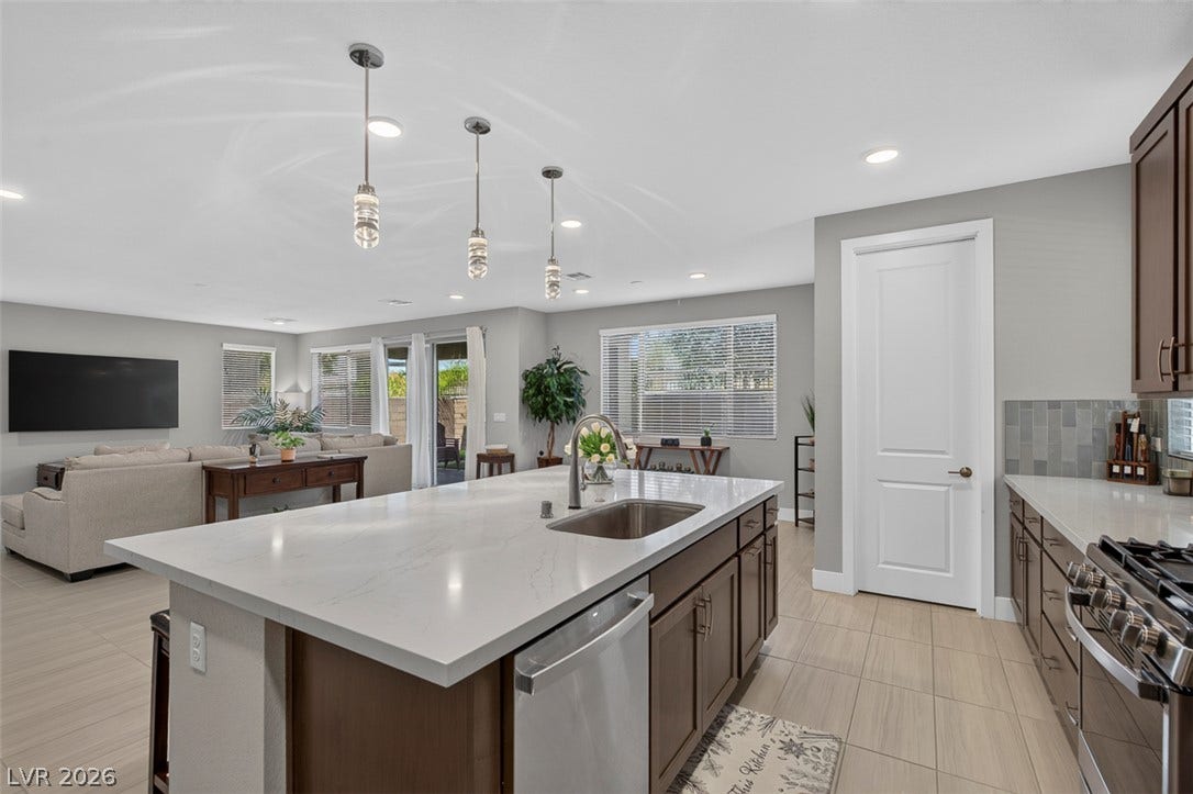 6849 Desert Finch Street, North Las Vegas, NV 89084 An open floorplan seamlessly connects the stone-counter kitchen with the casual living area.