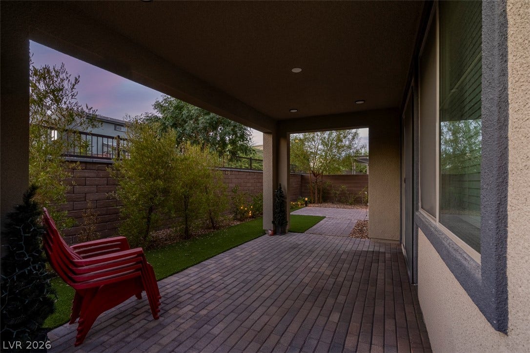 6849 Desert Finch Street, North Las Vegas, NV 89084 Sheltered brick pavers define this outdoor living space overlooking a landscaped backyard.