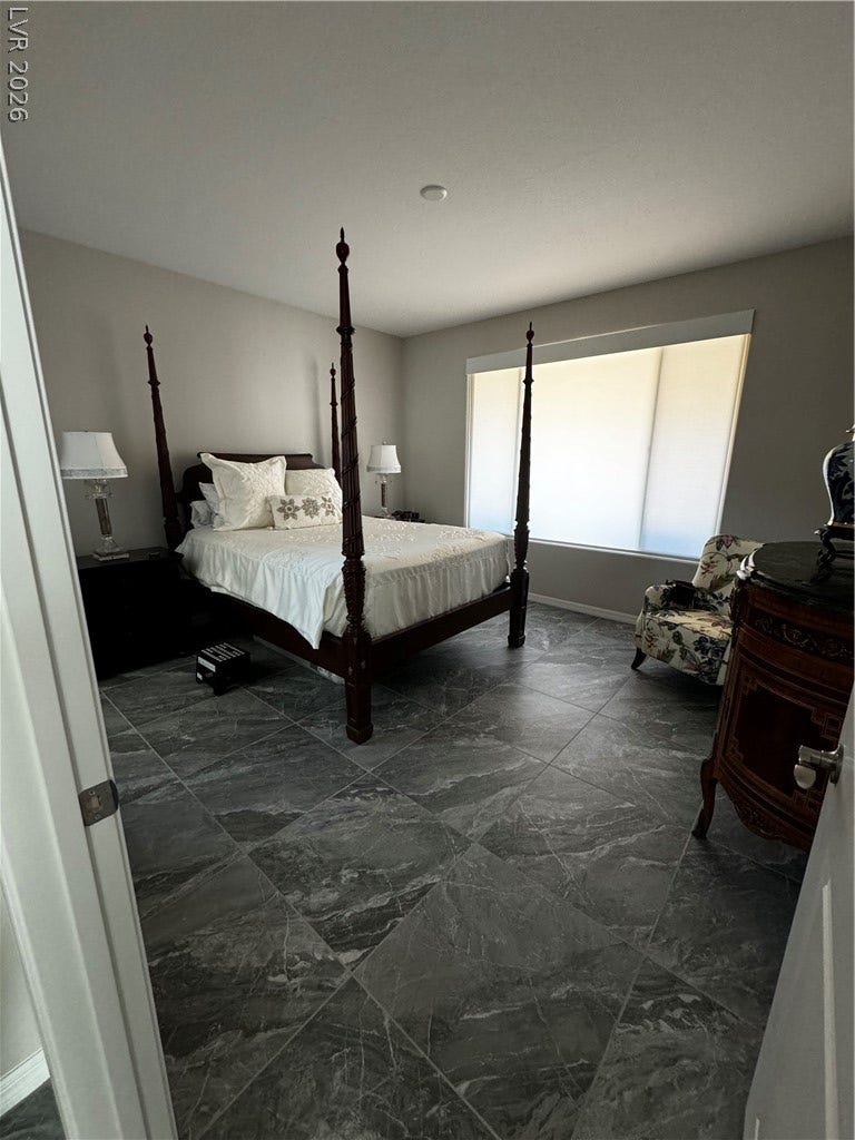 162 Palm Fox Court, Henderson, NV 89011 Polished tile flooring and high ceilings elevate this peaceful, sunlit bedroom retreat.