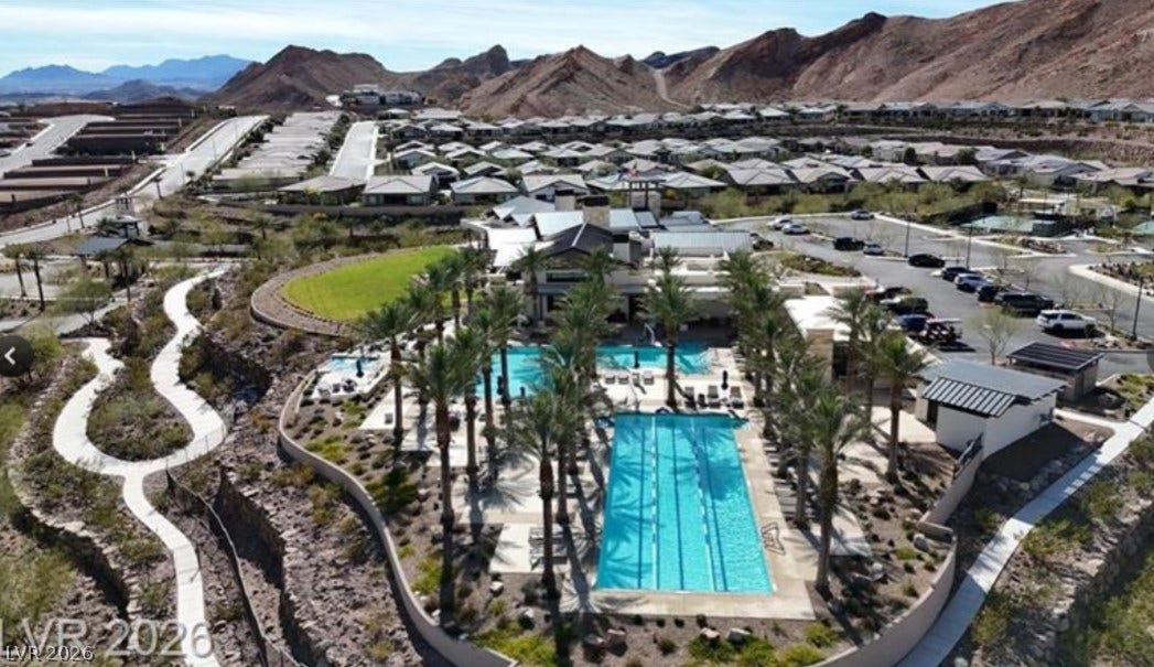 162 Palm Fox Court, Henderson, NV 89011 Dramatic mountain backdrops frame a community recreational center complete with pristine swimming pools.
