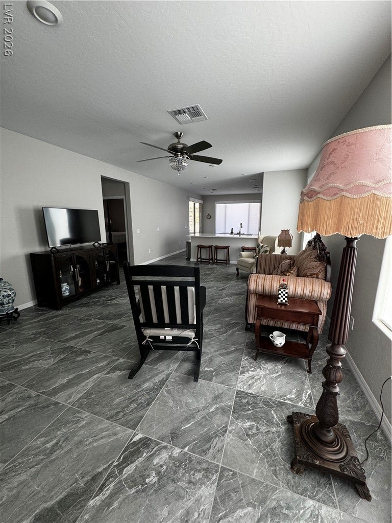 162 Palm Fox Court, Henderson, NV 89011 Gleaming stone tile flooring stretches across a highly versatile, open-concept living space.