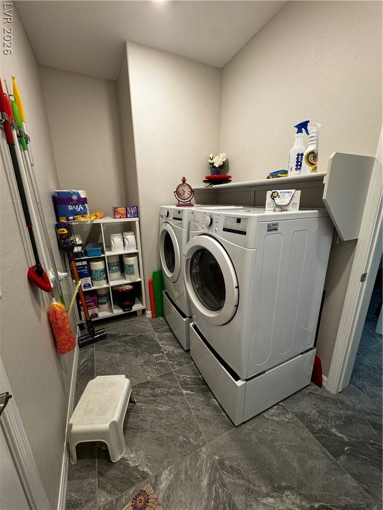 162 Palm Fox Court, Henderson, NV 89011 Functional laundry space showcases durable stone look tile flooring and practical built-in shelving.