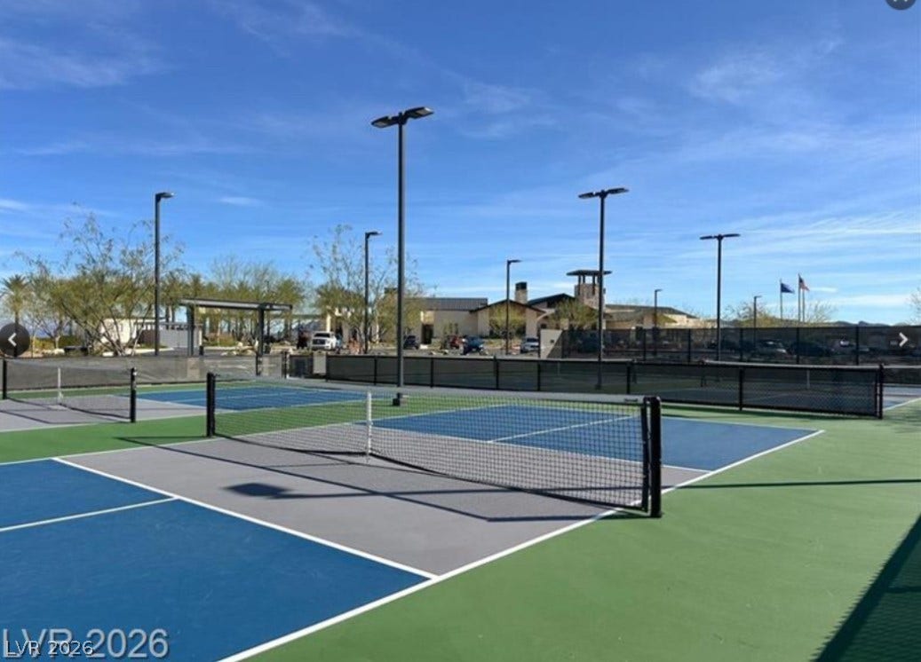 162 Palm Fox Court, Henderson, NV 89011 Professional outdoor courts sit ready for recreation under clear blue desert skies.