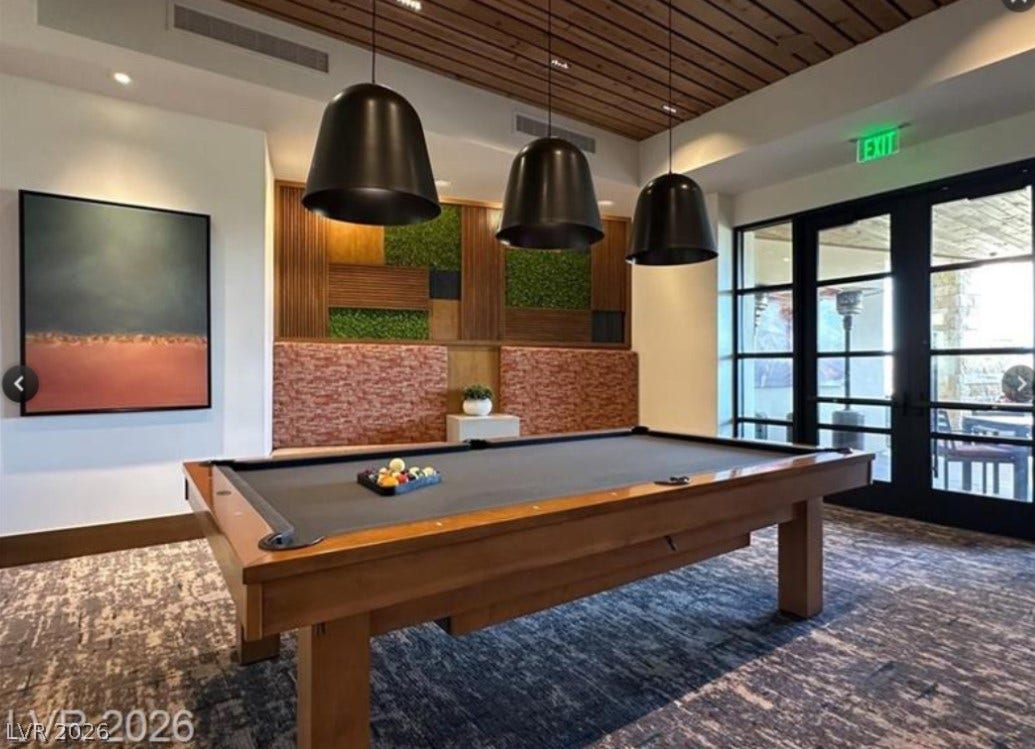 162 Palm Fox Court, Henderson, NV 89011 Gleaming glass doors open to the outdoors from this wood-ceilinged recreational space.