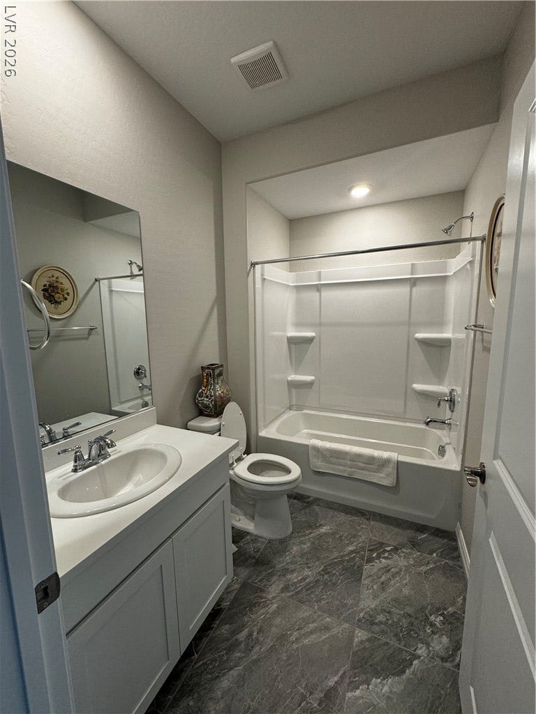 162 Palm Fox Court, Henderson, NV 89011 Gleaming stone tile flooring and a classic vanity enhance this beautifully appointed bathroom.
